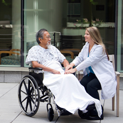 Doctor Attending to Patient in a Wheelchair Doctor Attending to Patient in a Wheelchair